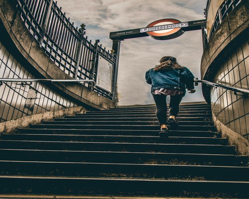 A person climbing subway stairs