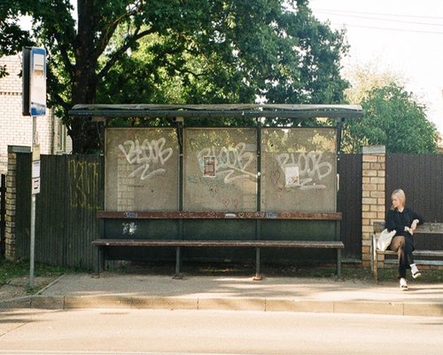 Someone waiting calmly at a bus stop